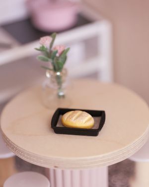 Freshly baked dollhouse bread loaves with baking tray
