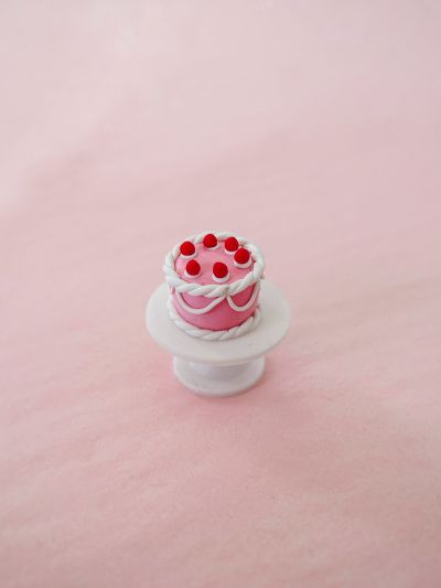 Dollhouse miniature pink cake with red cherries